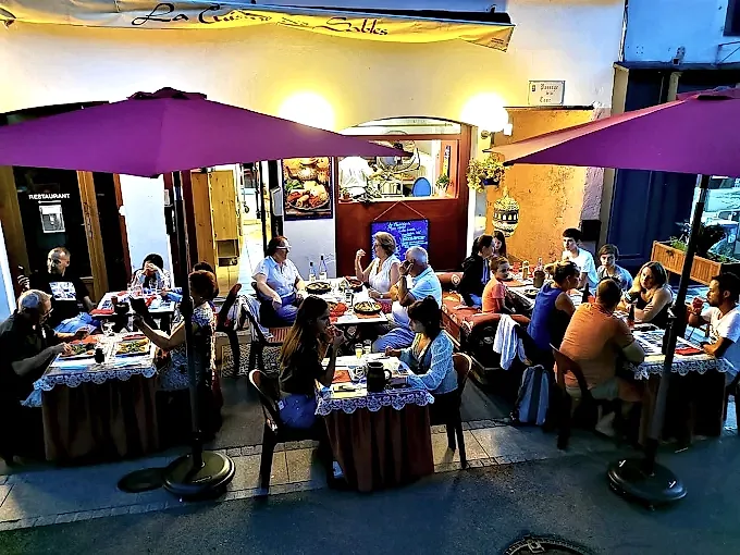 Terrasse animée un soir d'été devant le restaurant